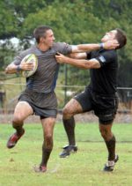 Two rugby players fighting for the ball